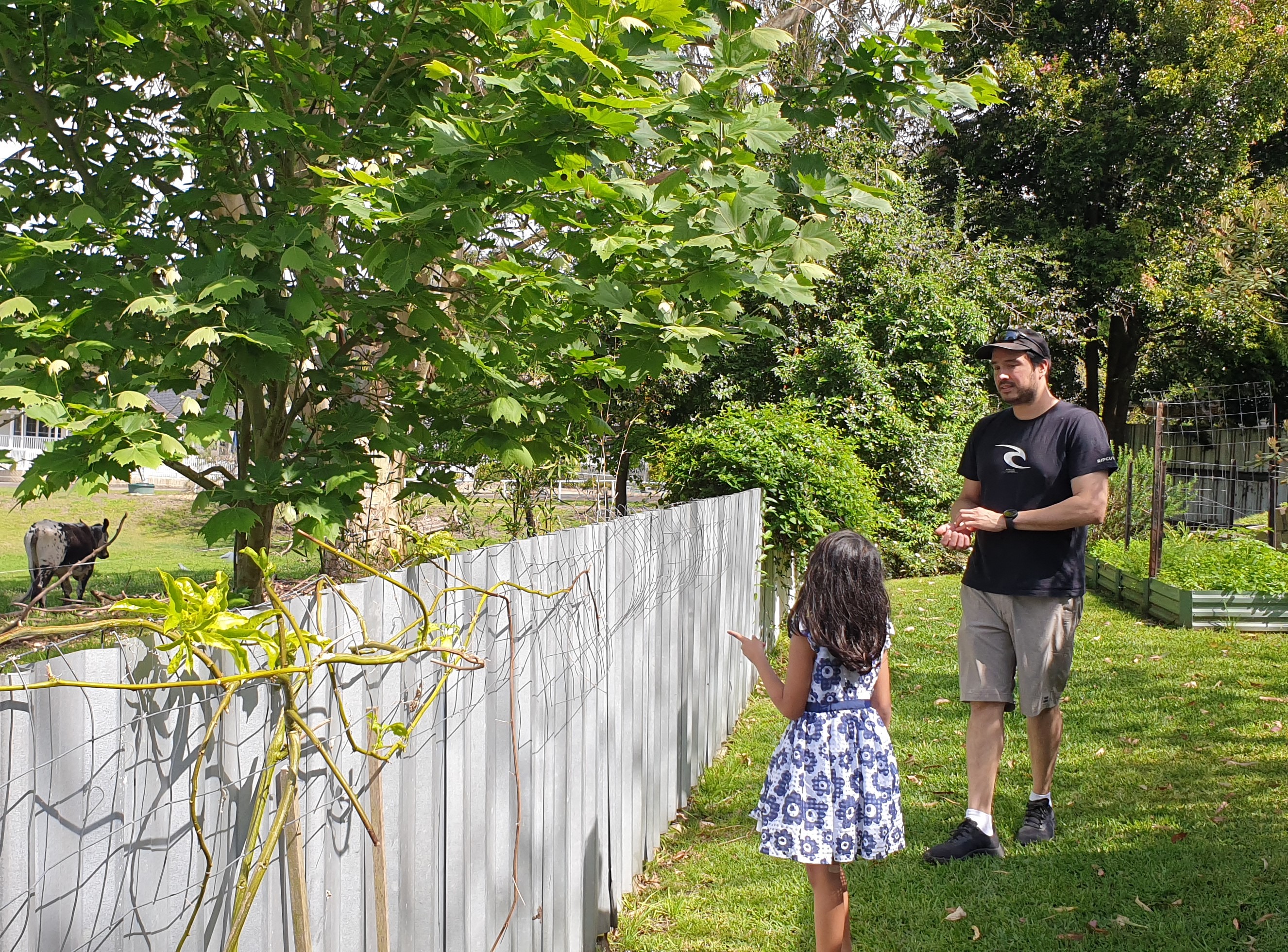 OTA staff member Byron Arcia with his daughter outside in the garden