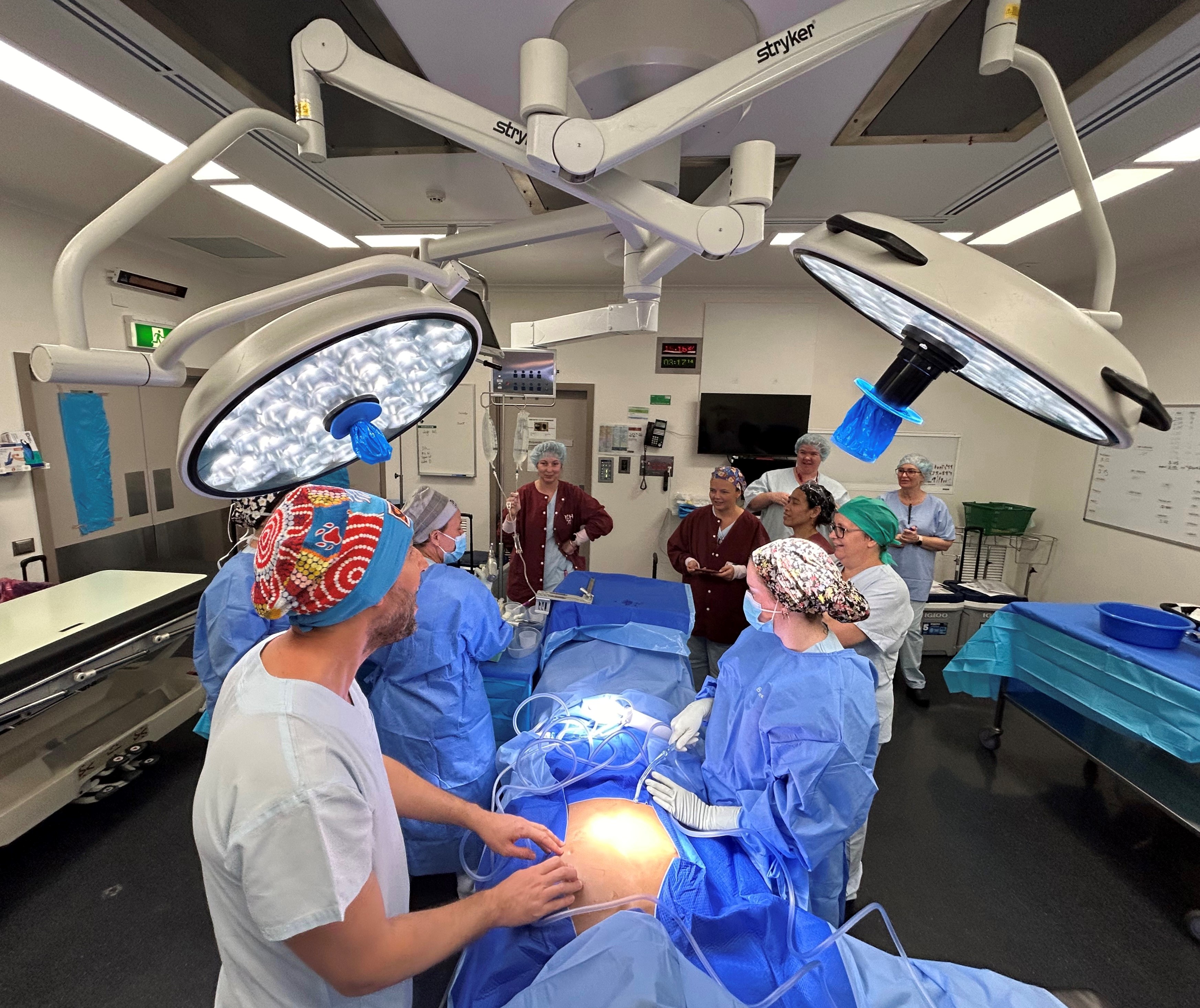 A group of nurses take part in an education session in a hospital operating theatre