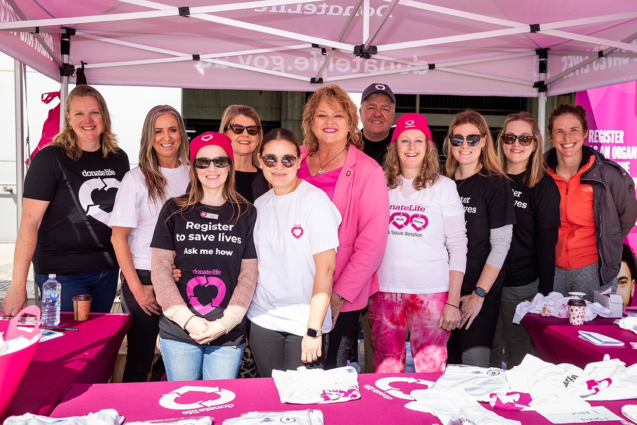 A group of people stand together for a photo at the DonateLife stall at the Step Up to Save Lives launch.