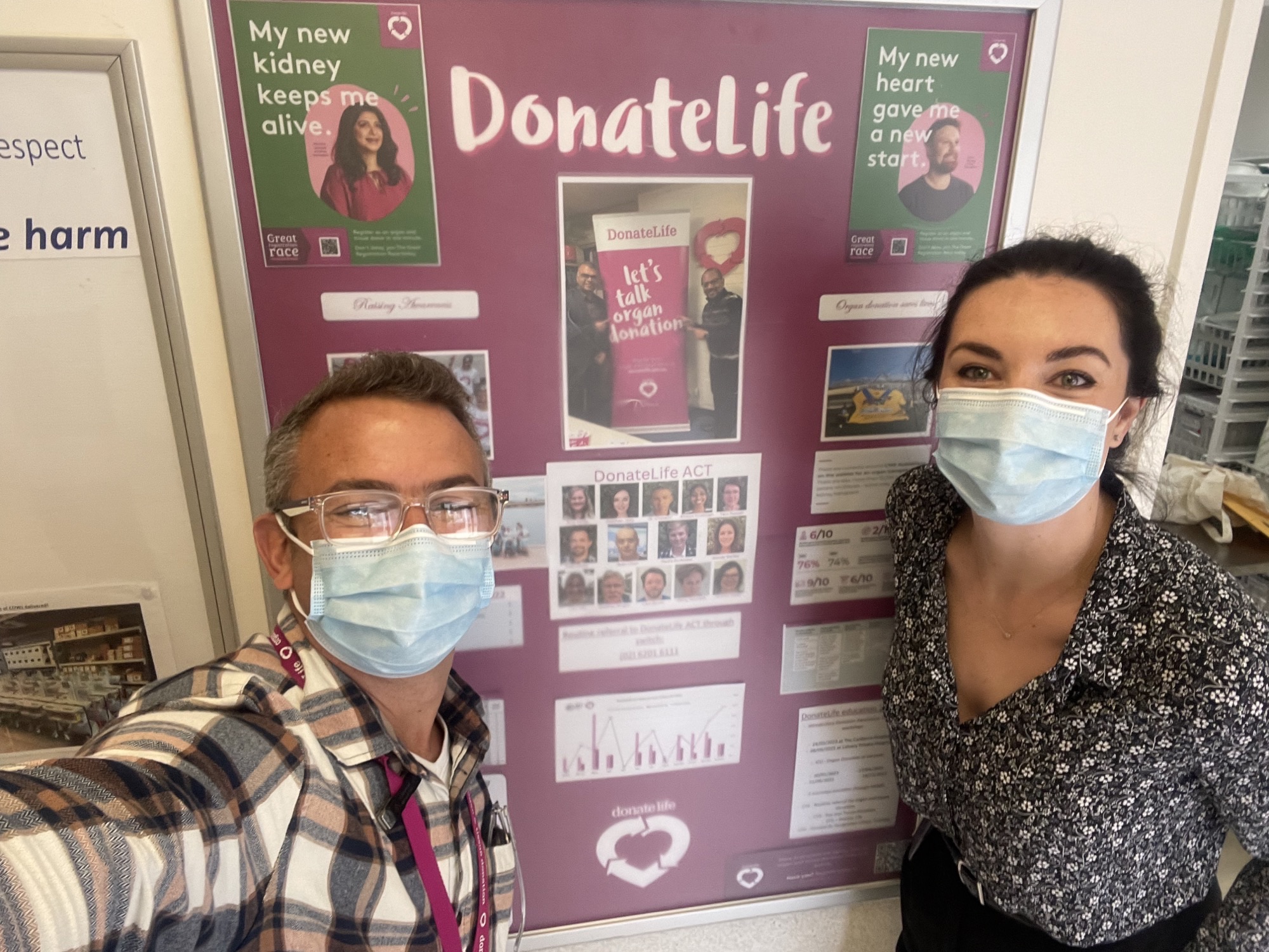 DonateLife ACT staff JC and Sioban in front of the DonateLife ACT hospital noticeboard display