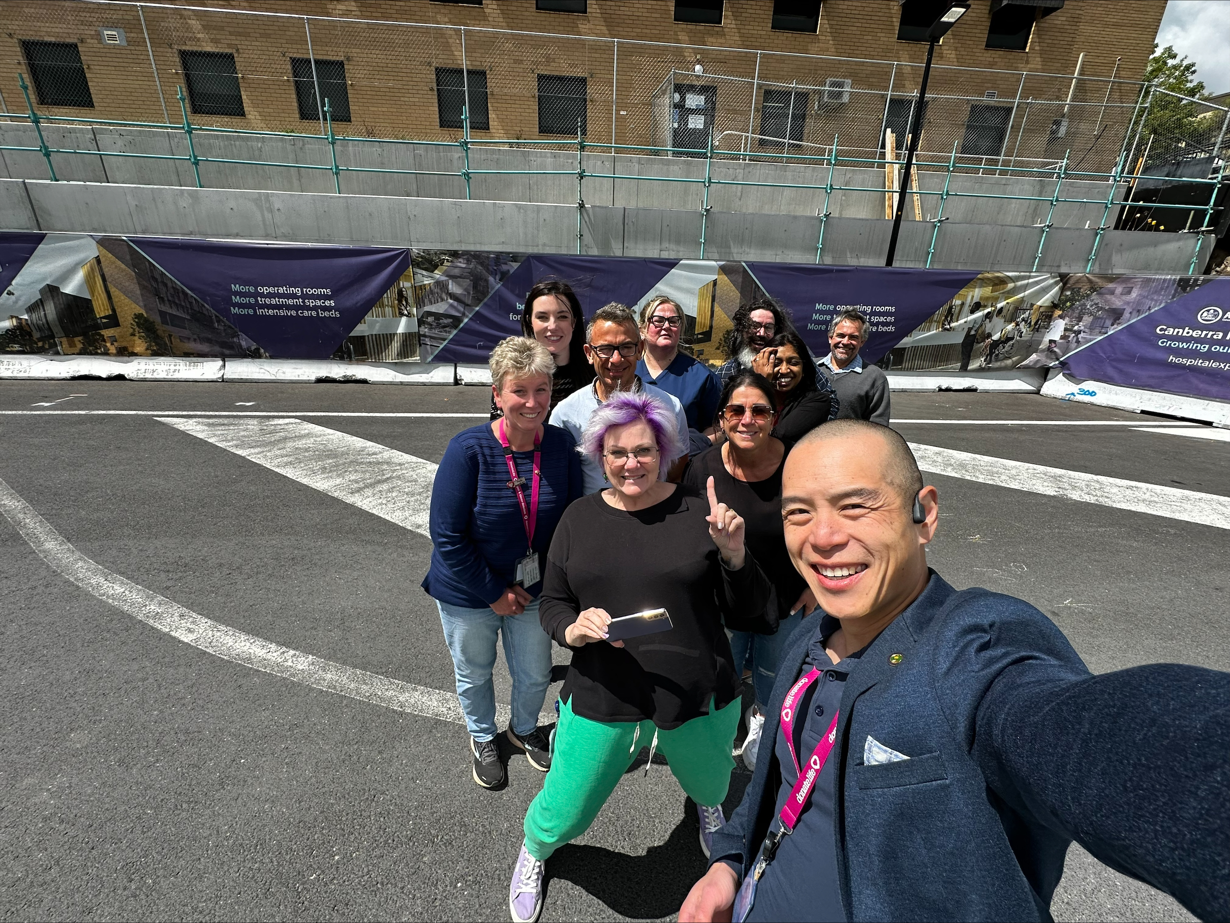 The DonateLife ACT team pose for a photo in front of the site for the new Critical Services Building of the Canberra Hospital.