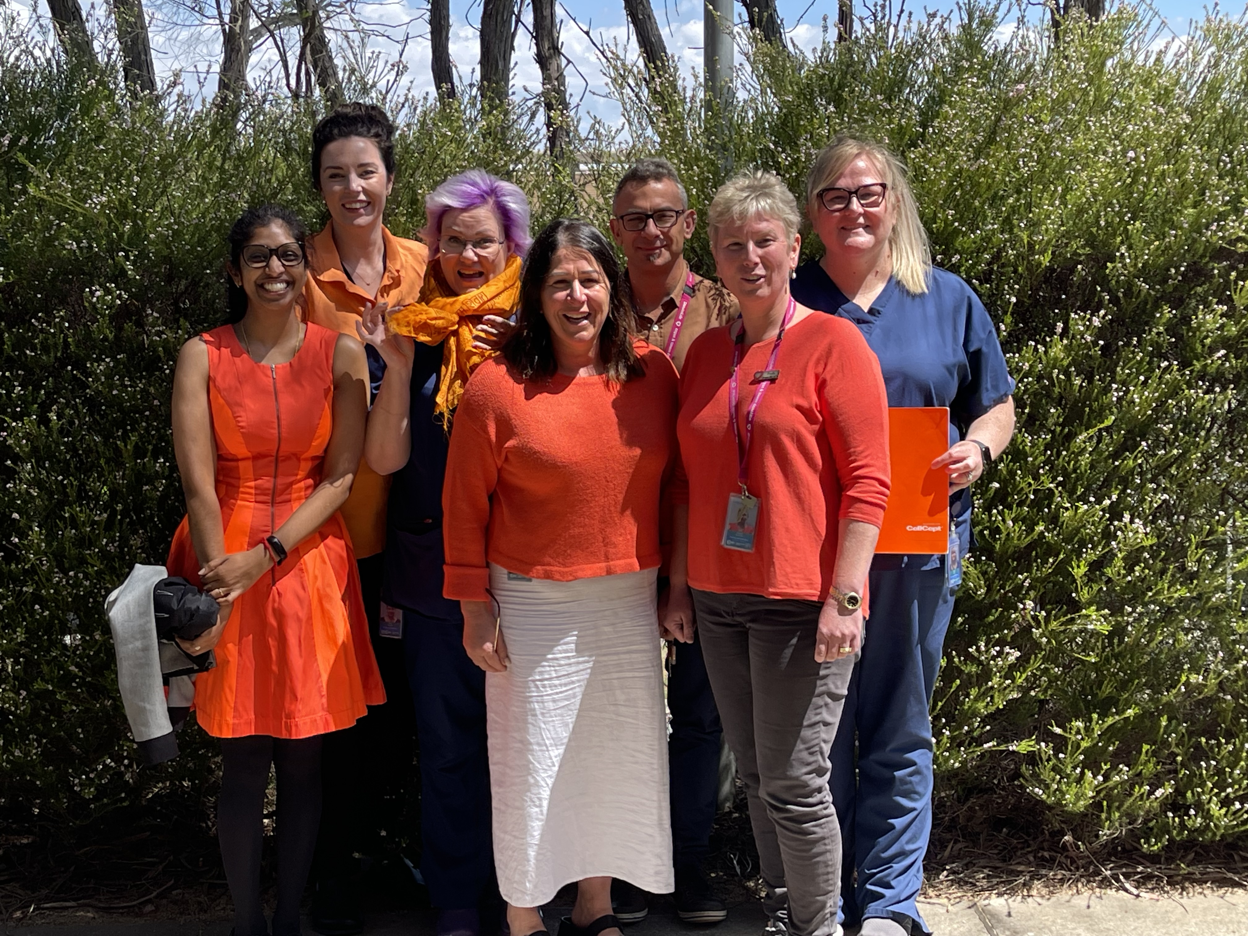 DonateLife ACT staff post for a photo wearing orange to celebrate Saffron Day.