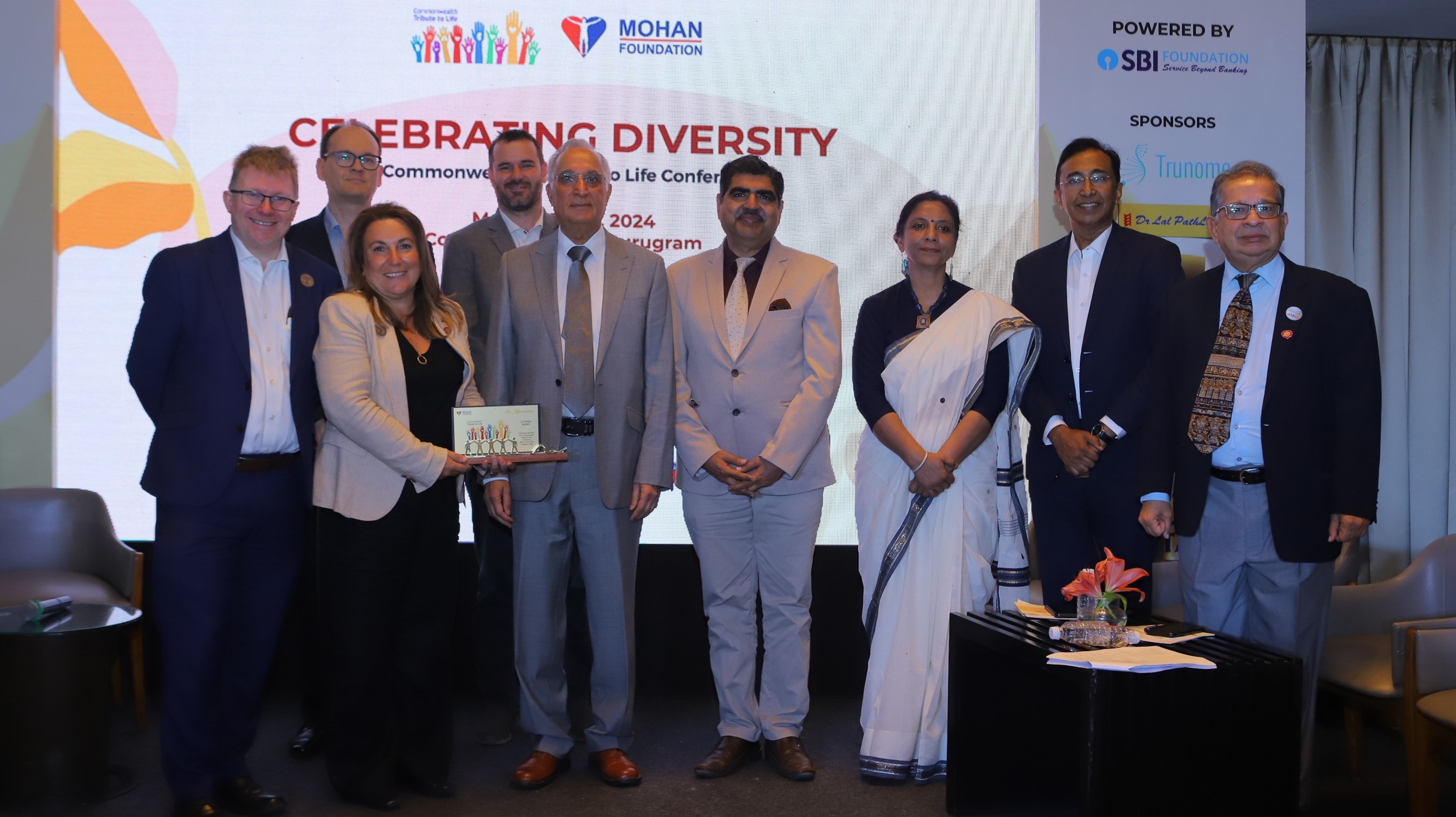 A group photo of organisers and leaders at a conference.