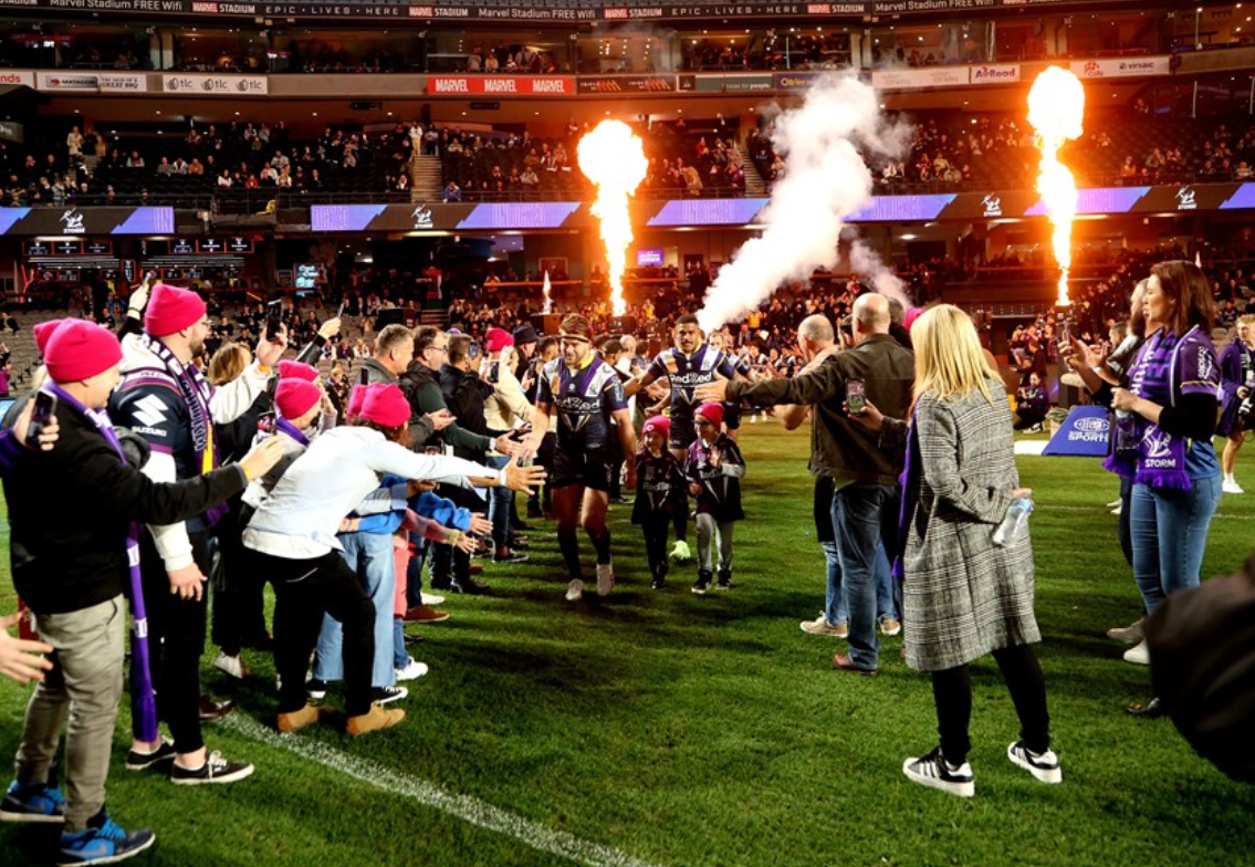 Photo of the run on tunnel with Melbourne storm running through it and people wearing magenta DonateLife beanies