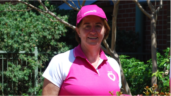 A photo of a woman wearing a DonateLife shirt and hat, smiling at the camera.