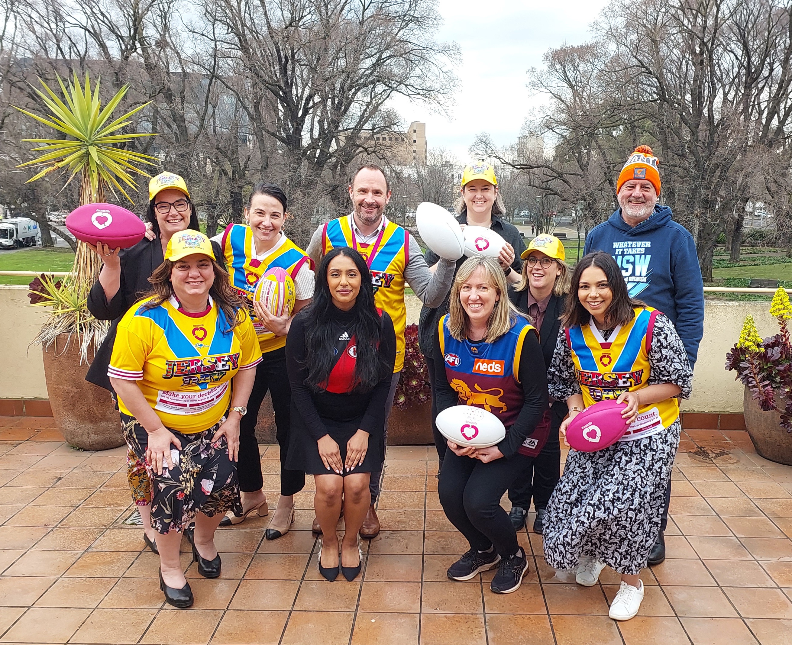 Staff wearing their Jersey Day jerseys and holding DonateLife balls