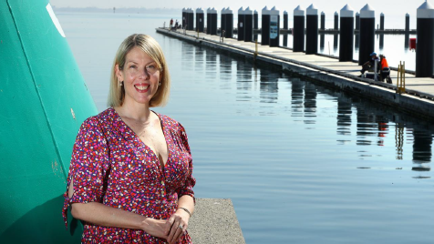 A photo of liver recipient Jessica Chappel, standing in front of the water at the Geelong docks.