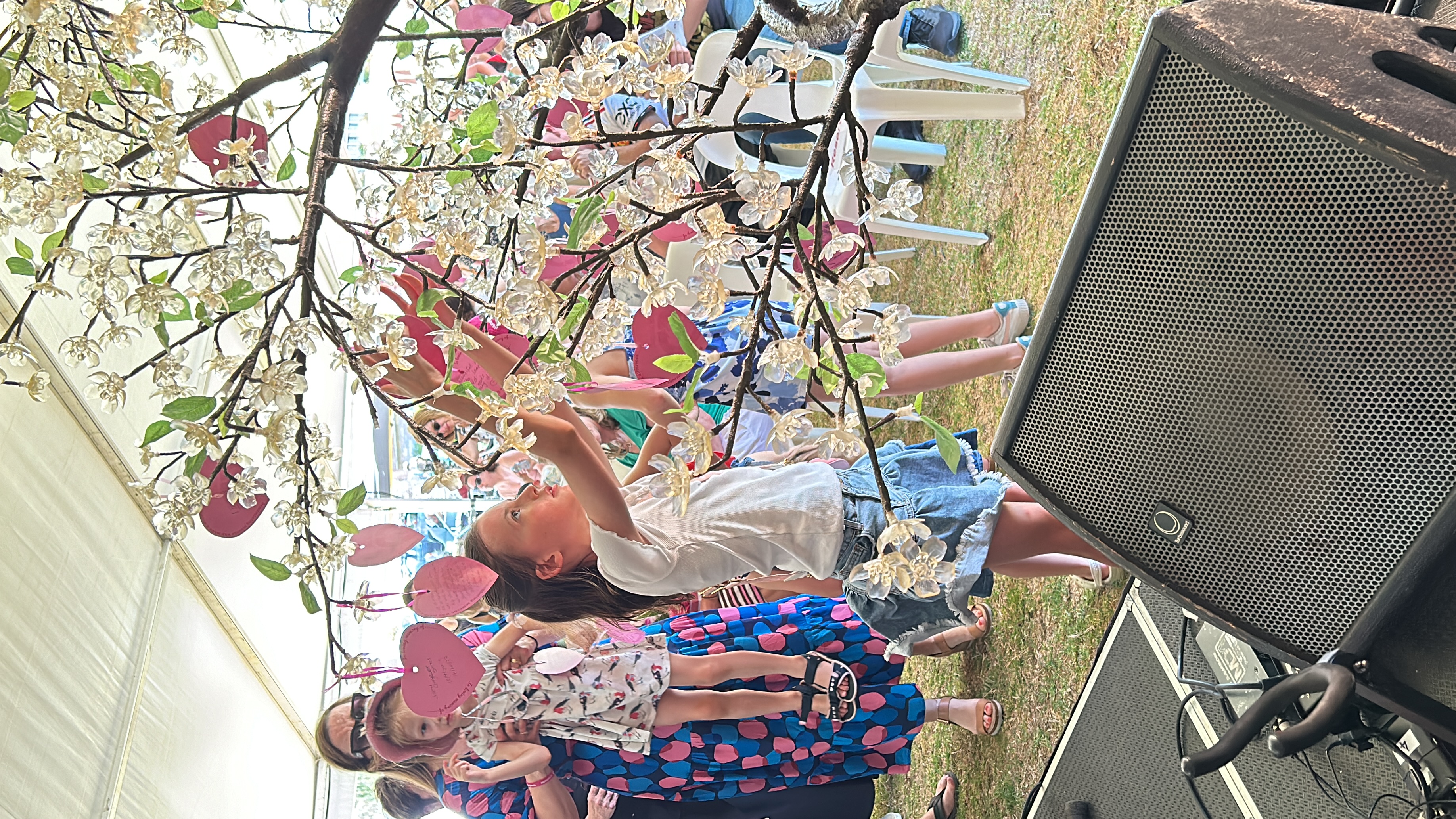 A child at the Service of Remembrance in Perth adds a message to the Tree of Hearts.