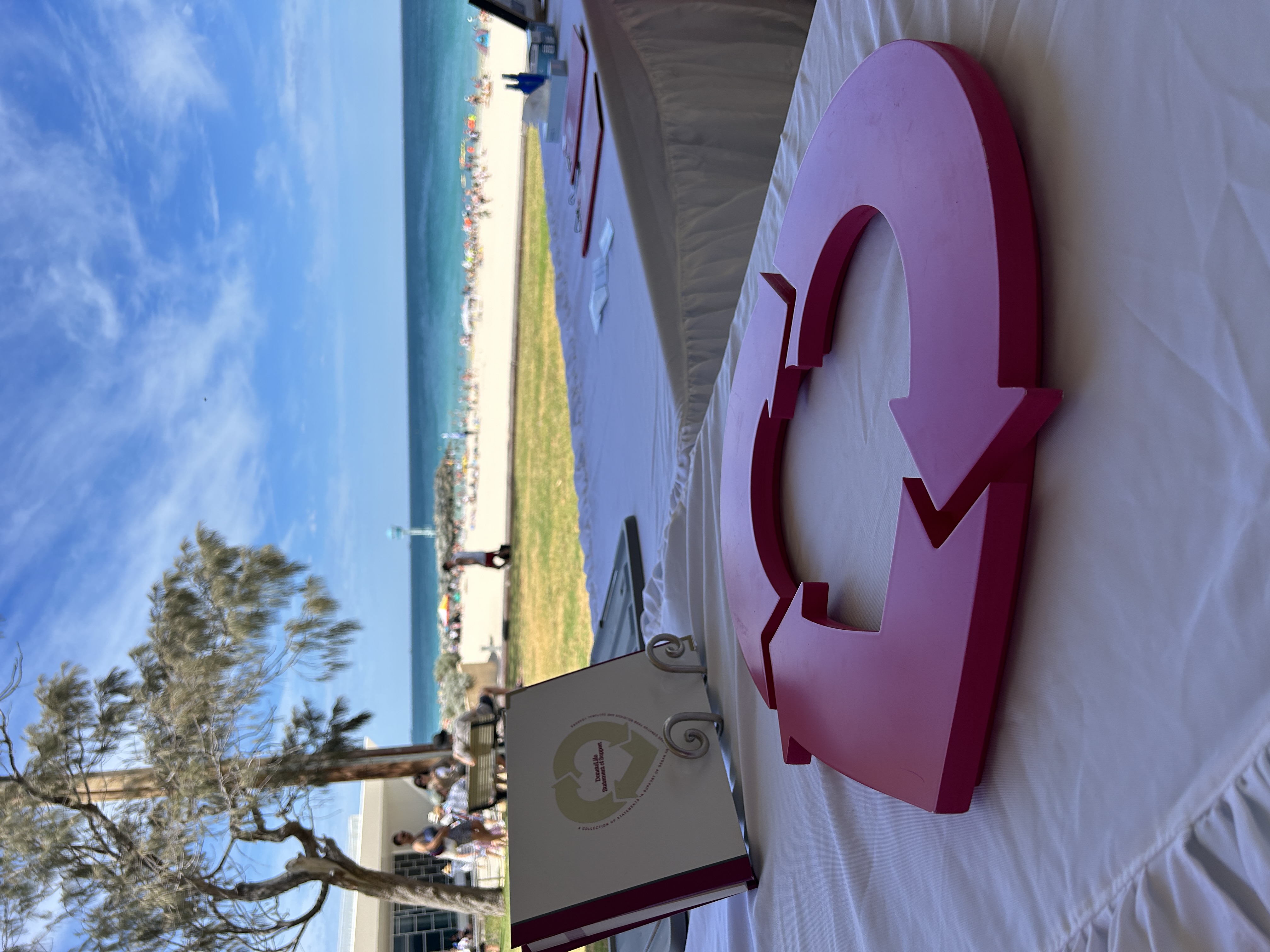 The DonateLife heart logo on a table ahead of the Service of Remembrance, with the City Beach in the background.