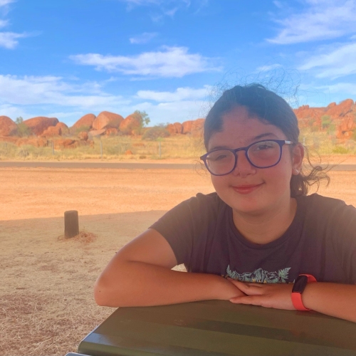 Sienna in nature, smiling at camera